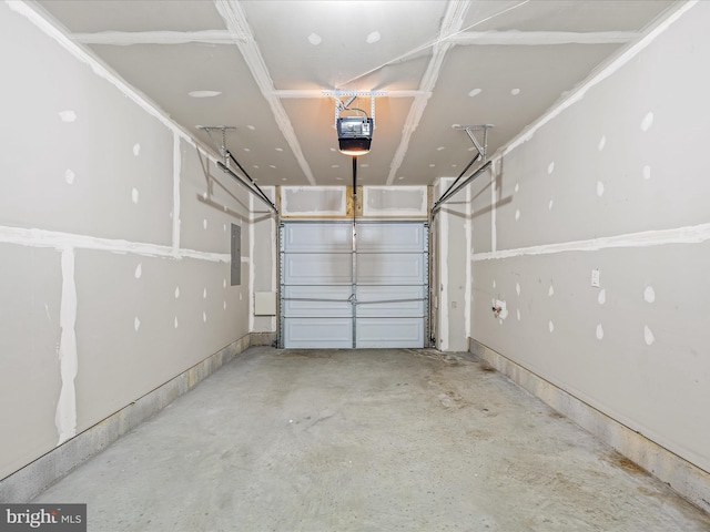 garage with a garage door opener and electric panel