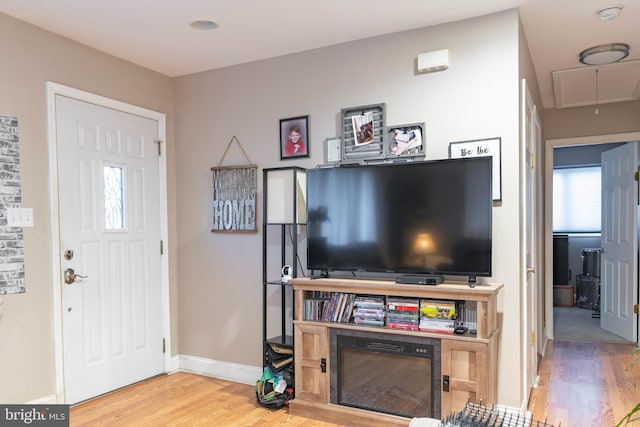 foyer with baseboards and wood finished floors