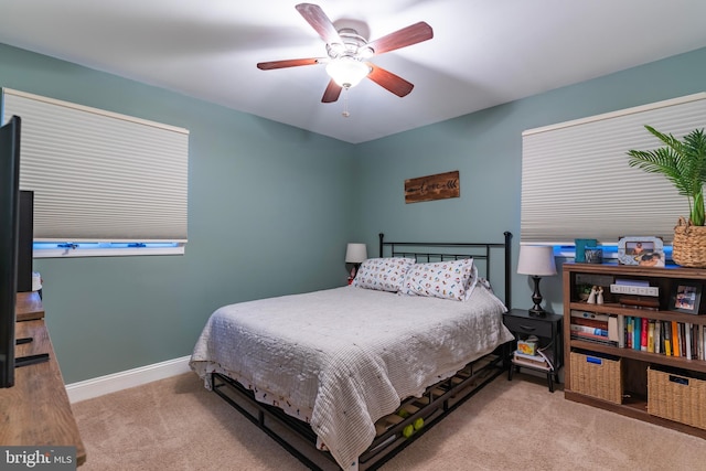 carpeted bedroom featuring a ceiling fan and baseboards