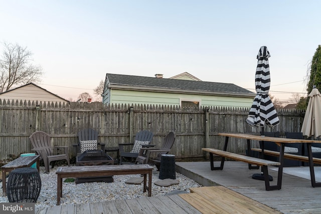 wooden terrace with a fenced backyard