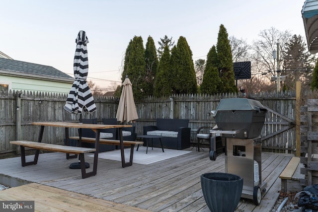 deck featuring a fenced backyard and grilling area