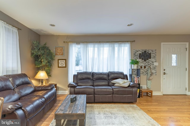 living room with light wood-style flooring and baseboards