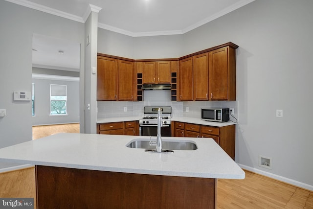 kitchen featuring tasteful backsplash, appliances with stainless steel finishes, brown cabinetry, crown molding, and light countertops