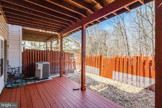 wooden terrace featuring central AC unit and fence