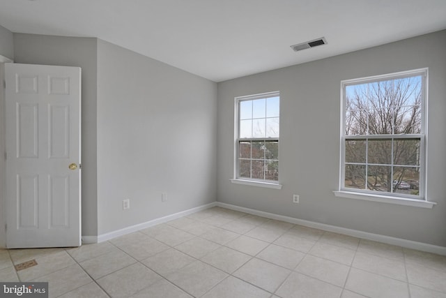 unfurnished room with light tile patterned floors, baseboards, and visible vents