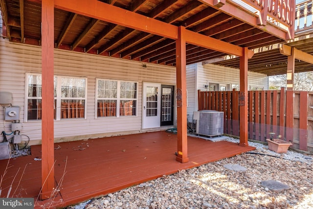 wooden terrace featuring central AC unit and fence