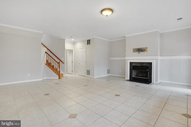 unfurnished living room featuring stairway, a fireplace with flush hearth, visible vents, and light tile patterned floors