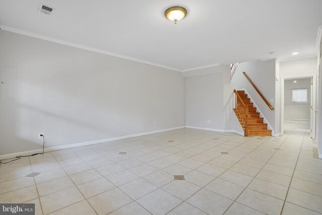 unfurnished room with light tile patterned floors, baseboards, visible vents, and ornamental molding