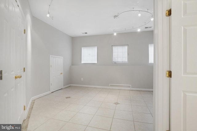 unfurnished room with light tile patterned floors, visible vents, and baseboards