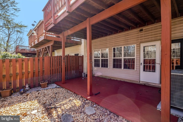 view of patio / terrace with fence, a wooden deck, and central air condition unit