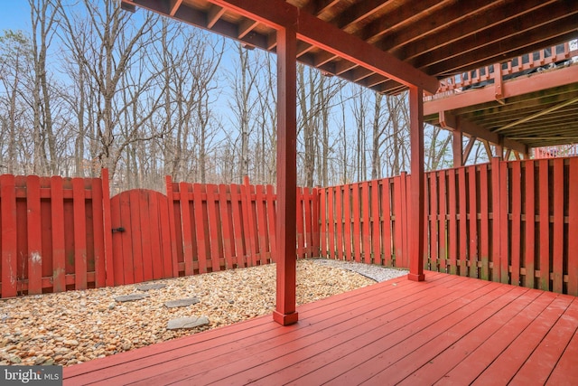 deck with a fenced backyard and a gate