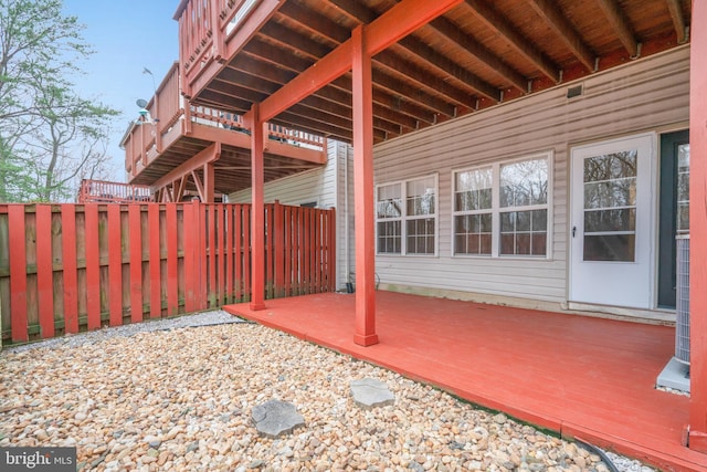 view of patio / terrace with a wooden deck and fence