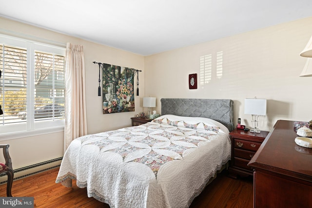 bedroom featuring baseboard heating and wood finished floors