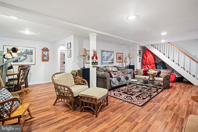 living room with light wood-style floors, recessed lighting, baseboards, and stairs