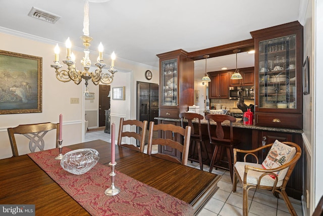 dining space featuring light tile patterned floors, an inviting chandelier, visible vents, and crown molding