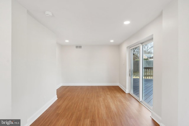 spare room featuring recessed lighting, visible vents, baseboards, and wood finished floors