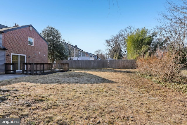 view of yard with fence and a deck