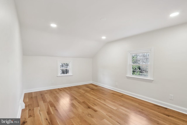 bonus room with vaulted ceiling, recessed lighting, light wood-type flooring, and baseboards