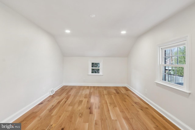 bonus room featuring lofted ceiling, recessed lighting, light wood-type flooring, and baseboards