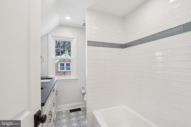 bathroom featuring lofted ceiling, toilet, visible vents, vanity, and baseboards