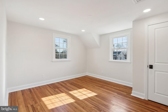 bonus room with recessed lighting, plenty of natural light, wood finished floors, and baseboards