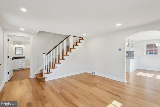 entryway featuring light wood-style flooring, stairs, visible vents, and recessed lighting