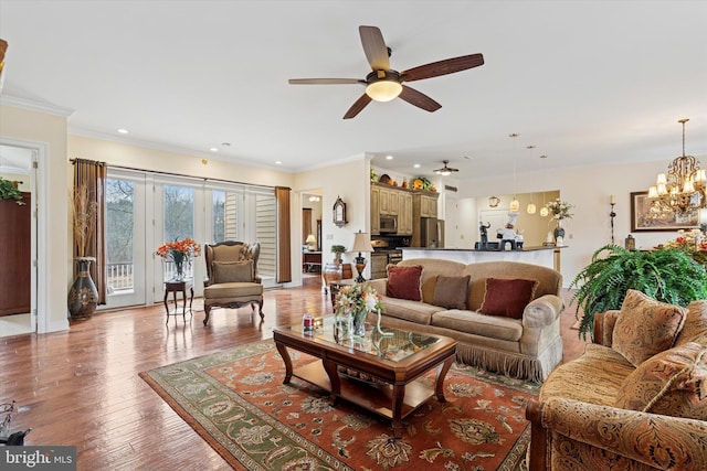 living room featuring light wood-style flooring, ornamental molding, and recessed lighting