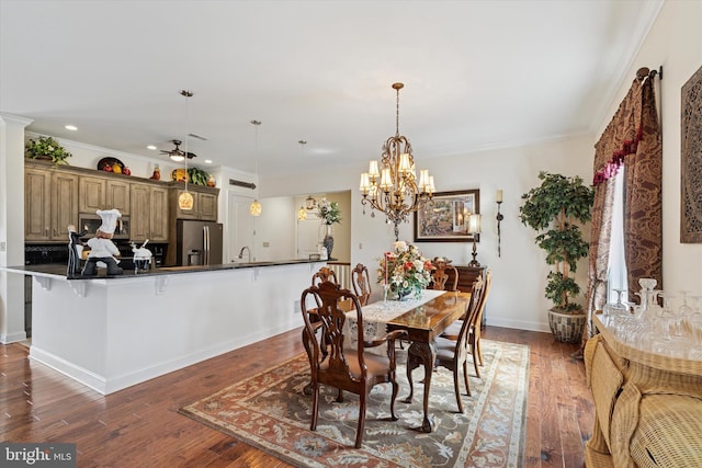 dining area featuring ornamental molding, hardwood / wood-style floors, a ceiling fan, and baseboards