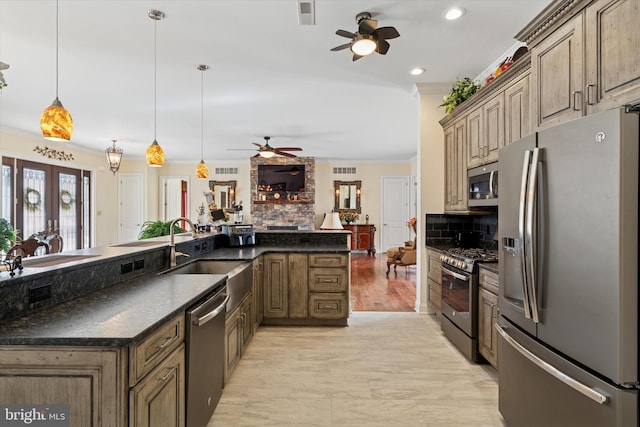 kitchen featuring stainless steel appliances, a sink, visible vents, tasteful backsplash, and crown molding