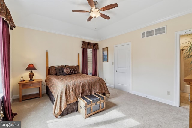 carpeted bedroom with baseboards, visible vents, a tray ceiling, and ornamental molding