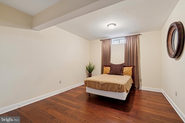 bedroom with hardwood / wood-style flooring and baseboards