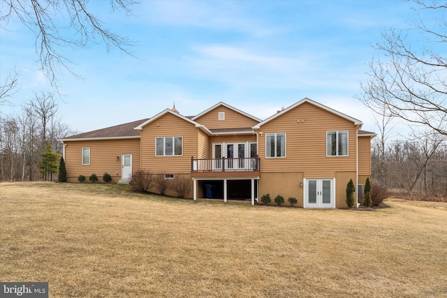 back of property featuring french doors, a yard, and a deck