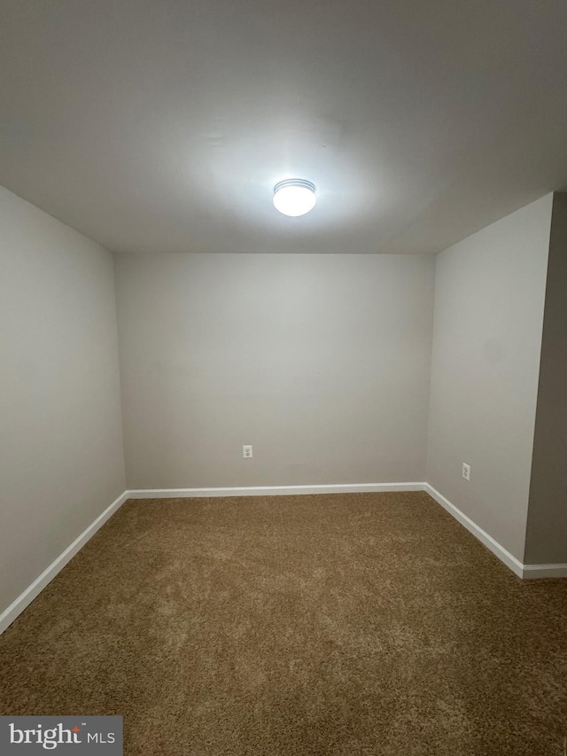 unfurnished room featuring carpet floors and baseboards