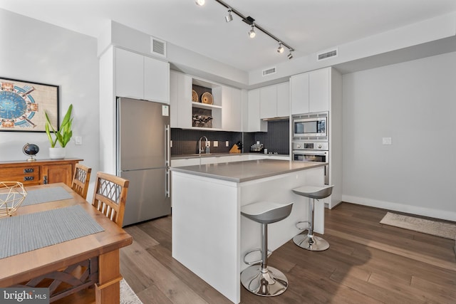 kitchen featuring stainless steel appliances, open shelves, visible vents, and white cabinets