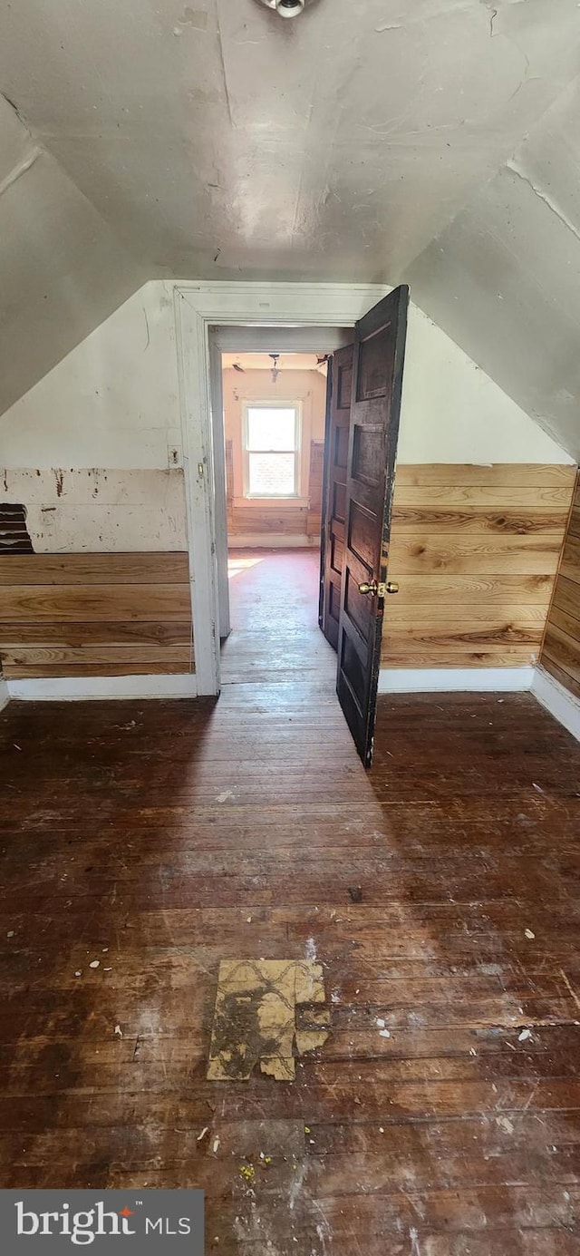 additional living space featuring hardwood / wood-style flooring and vaulted ceiling