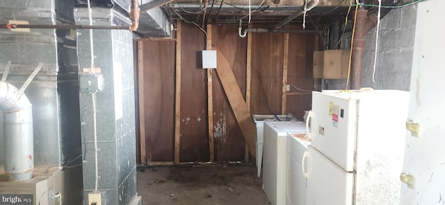 unfinished below grade area with freestanding refrigerator and washer and clothes dryer