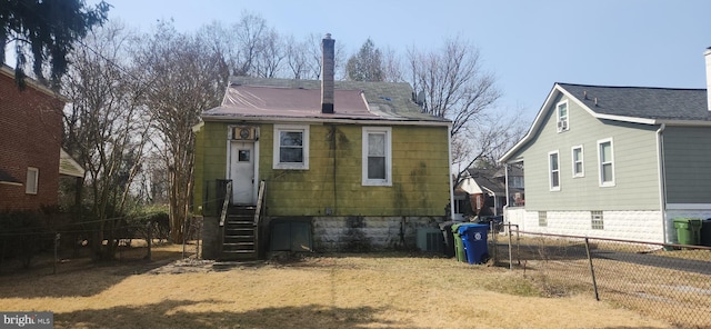 back of property featuring entry steps, fence, and central air condition unit