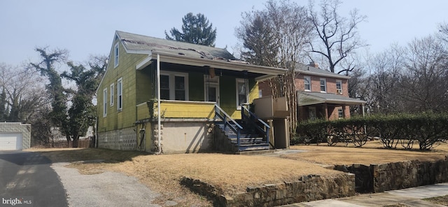 view of front of house featuring a porch and a chimney