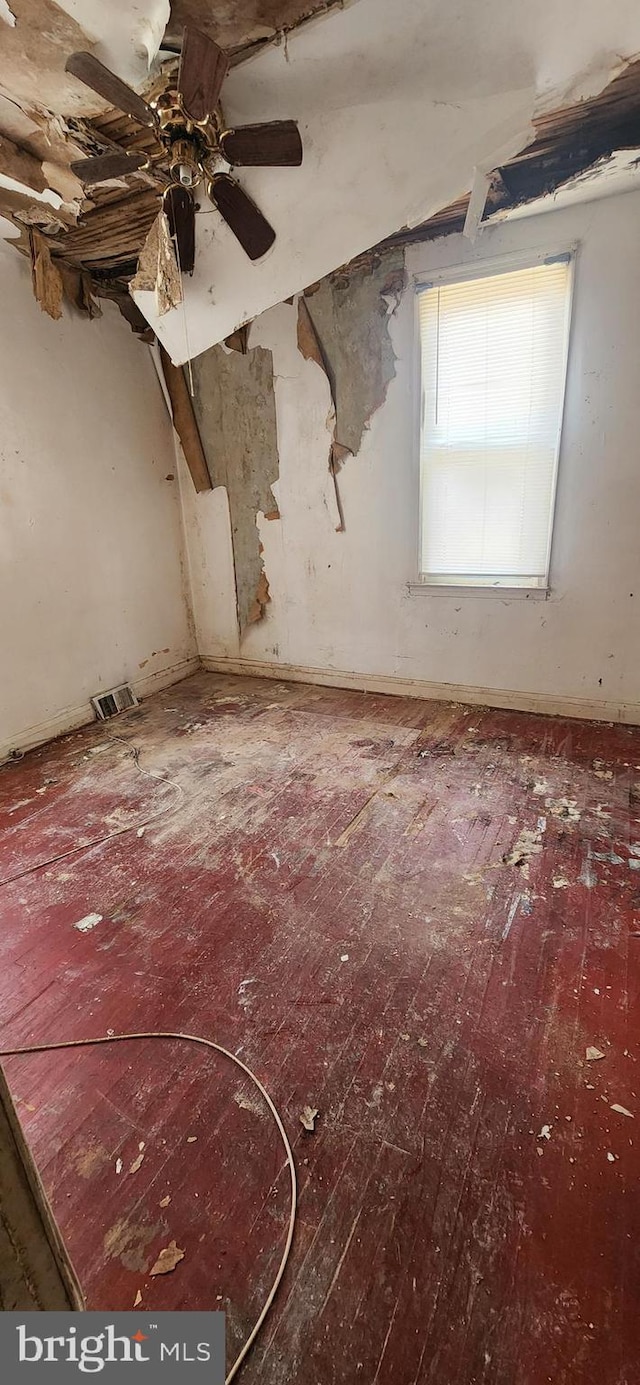 unfurnished room with visible vents and ceiling fan