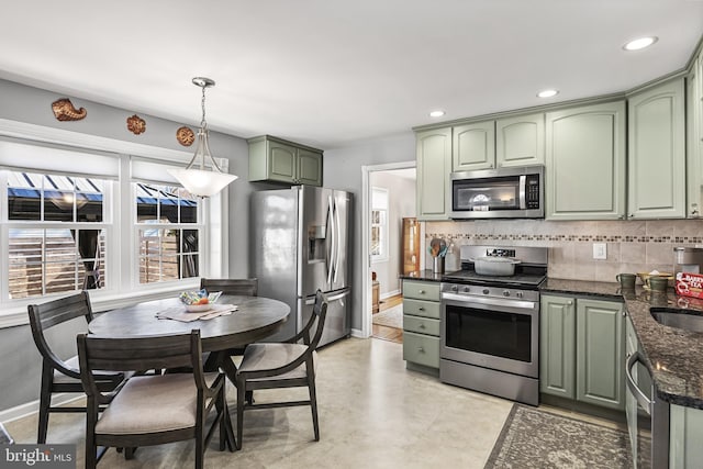 kitchen featuring green cabinets, tasteful backsplash, pendant lighting, and stainless steel appliances