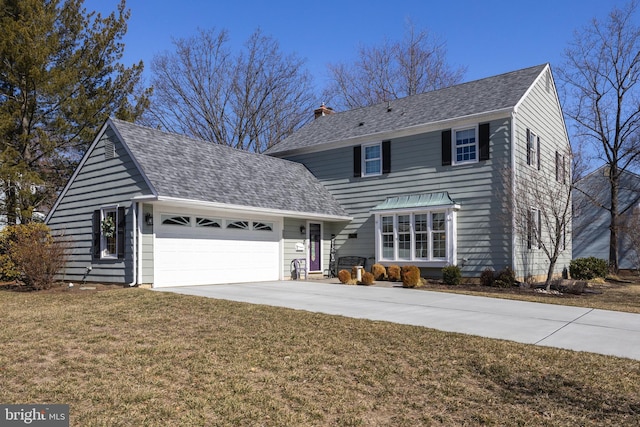 traditional-style home with roof with shingles, a chimney, concrete driveway, an attached garage, and a front lawn