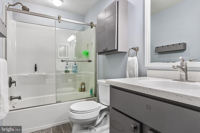 full bathroom featuring shower / bath combination with glass door, vanity, and toilet