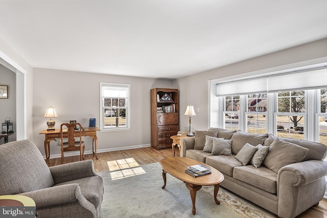 living room with light wood-style flooring and baseboards