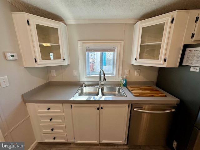 kitchen featuring light countertops, glass insert cabinets, white cabinets, a sink, and dishwasher