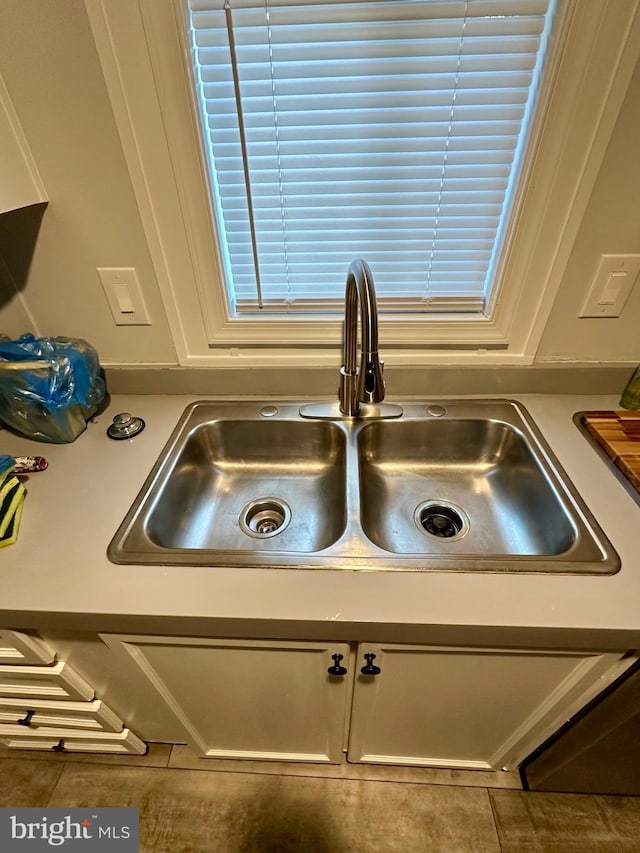 details featuring white cabinets and a sink