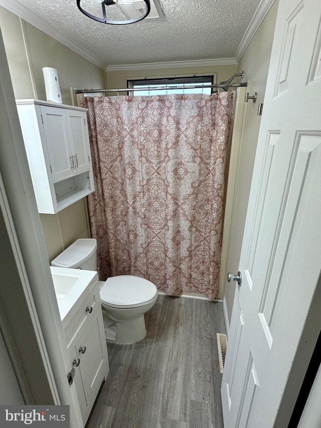 full bathroom with toilet, crown molding, a textured ceiling, and wood finished floors