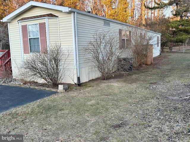 view of side of home featuring fence