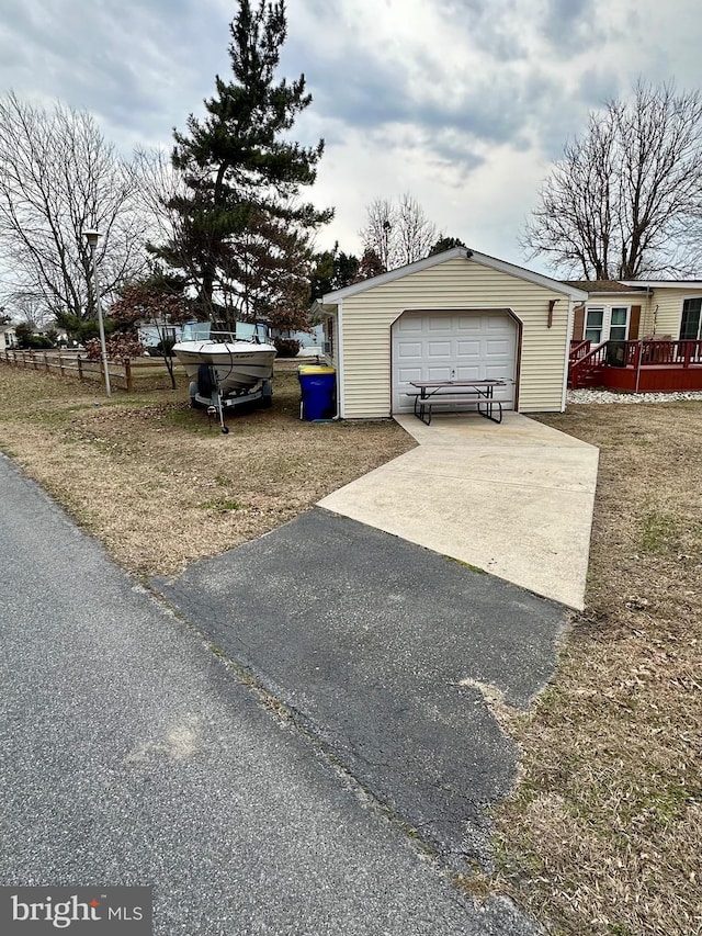 exterior space featuring driveway and an outdoor structure