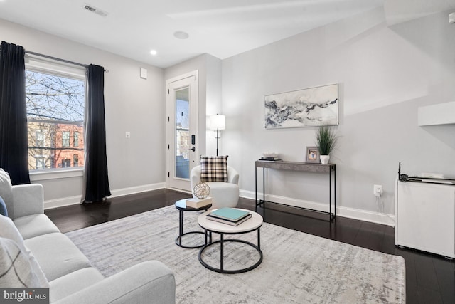 living room with dark wood-type flooring, recessed lighting, visible vents, and baseboards