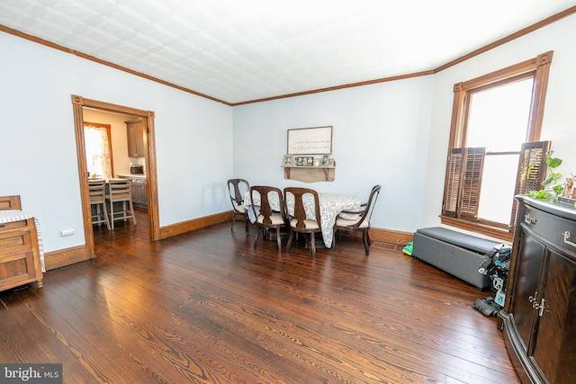 dining area featuring dark wood-style floors, baseboards, and crown molding